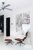 Modern home with Living Room, Ottomans, Lamps, Recliner, and Floor Lighting. The other end of the living room features an Eames Lounge alongside the playful Hello Lamp from Normann Copenhagen. The loose lines of the Hetkia Moments mural by Maija Loukari for Marimekko characterises a bit of chaos and contrast for the minimal space. Photo 3 of Living in Monochrome, far away from Nordic lands