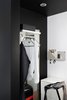 Modern home with Bedroom, Recessed Lighting, Shelves, and Dresser. The triangle clothes hanger from RoomSafari reminds a musical instrument because of its triangular form and the missing hook, becoming as integral an element as the closet space. The small folded shelves by Muuto play a supporting cast, neatly tucking away a few everyday use stuff in the closet. Photo 9 of Living in Monochrome, far away from Nordic lands