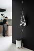 Modern home with Ceiling Lighting. The aesthetics of Norm Architects is minimalistic, functional and meets real-life needs. Even the dust bin designed by Jonas Bjerre-Poulsen and Kasper Rønn of Norm Architects for Menu may incite receptacle envy. The glossy white lacquered steel bin is matched against a black wall along the entryway to the kitchen. The Wardrope designed by Veronica Wildgruber and Susan Stofer for Authentics has an interesting design with a polyamide rope hanging from the ceiling and metal hooks sliding along it. The beautiful Veljekset pattern kitchen towel by Marimekko was a flawless addition on these hooks. Marimekko, the Finnish label that inspires with their bold use of colors and patterns, creates a striking contrast with the black & white Räsymatto pattern by Maija Loukari, expressed through various materials and objects at home, from textiles in kitchen to ceramics in living room to floor mats in bathrooms. Photo 11 of Living in Monochrome, far away from Nordic lands