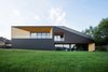 Modern home with Exterior, Tile Roof Material, Stone Siding Material, Gable RoofLine, and House Building Type. In the south, the house opens up to the garden. The most important rooms were situated in the southern part of the plot. They open to the sun, garden and the view. Photo of BLACK ROCK
