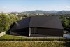 Modern home with Exterior, House Building Type, Stone Siding Material, Tile Roof Material, and Gable RoofLine. Aerial view from the north - house and the mountains. Photo 2 of BLACK ROCK