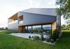 Modern home with Exterior, Tile Roof Material, Cabin Building Type, House Building Type, Gable RoofLine, Hipped RoofLine, Wood Siding Material, Stone Siding Material, and Shingles Roof Material. The southern wall is high and includes openings such as glazing, terrace and loggia, which provide the panoramic view. Photo 5 of BLACK ROCK