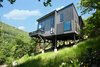 Modern home with Outdoor, Back Yard, Slope, Grass, Trees, Large Patio, Porch, Deck, and Landscape Lighting. The Angle House Photo 10 of The Angle House