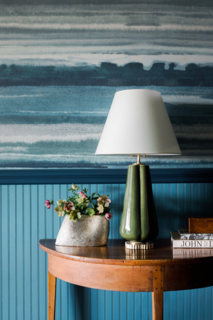 In the foyer, Phillip Jeffries’ tranquil blue Fade Sea Spray wallpaper gives a subtle nod to the nearby Blue Ridge Mountains, which guests have views of from the property. 