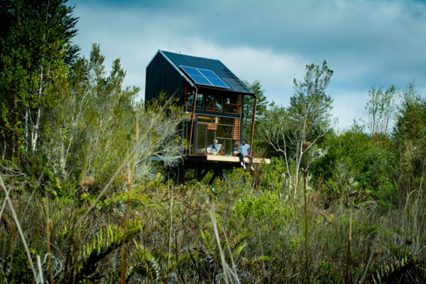 The two-story cabin runs solely off of solar power and rainwater. 