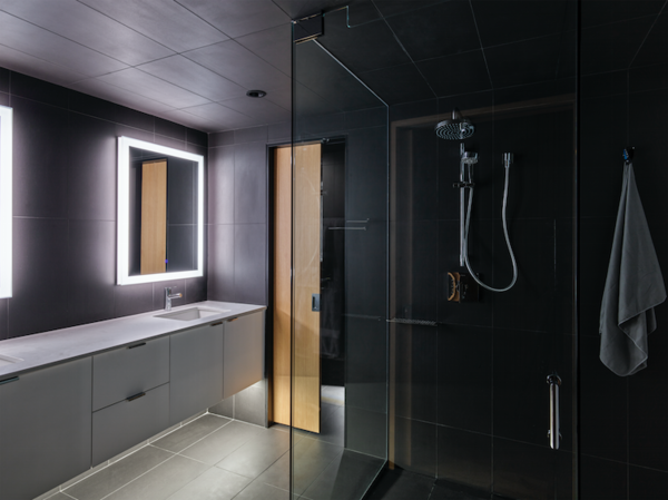 While most of the interior is clad in wood, the bathroom is covered in a sleek gray tile.