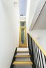 Modern home with Staircase, Wood Tread, Metal Railing, Metal Tread, and Wood Railing. Exit from basement apartment to backyard. Photo 11 of Sunset Park Row House