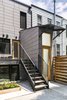 Modern home with Outdoor, Small Patio, Porch, Deck, Wood Patio, Porch, Deck, Vertical Fences, Wall, and Back Yard. Rear facade detail. Photo 4 of Sunset Park Row House