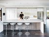 Modern home with Kitchen, Ceiling Lighting, Refrigerator, Microwave, Ice Maker, Dishwasher, Wood Cabinet, Drop In Sink, and White Cabinet. A simple, chic, elegant modern prefab open kitchen. Photo 5 of Orinda Connect 8+2