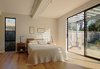Modern home with Bedroom, Ceiling Lighting, Medium Hardwood Floor, Table Lighting, Bed, Night Stands, and Chair. Connect 6 by Connect Homes interior image with view of the bedroom. Photo 5 of Palo Alto Connect 6