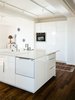 Modern home with Kitchen, Microwave, Drop In Sink, Dark Hardwood Floor, Ceiling Lighting, White Cabinet, Dishwasher, and Refrigerator. Smart. Green. Modern. Prefab. A neutral palette of finishes was chosen and applied to create a more spacious look in the kitchen of Connect 5. Photo 4 of Connect 5 Sonoma