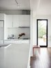 Modern home with Kitchen, Drop In Sink, White Cabinet, Refrigerator, Ceiling Lighting, Microwave, Dark Hardwood Floor, and Wall Oven. A chic, clean, modern design of the Connect 5 kitchen interiors. Photo 5 of Connect 5 Sonoma