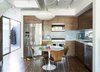 Modern home with Kitchen, Ceiling Lighting, Wall Oven, Medium Hardwood Floor, Refrigerator, Dishwasher, Microwave, Wood Cabinet, Drop In Sink, Pendant Lighting, and Ceramic Tile Backsplashe. Santa Monica Connect 4L Kitchen Interiors Photo 2 of Santa Monica Connect 4L