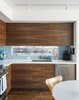 Modern home with Kitchen, Medium Hardwood Floor, Drop In Sink, Ceiling Lighting, Wood Cabinet, Dishwasher, Wall Oven, and Ceramic Tile Backsplashe. Santa Monica Connect 4L Kitchen Detail with book matched walnut cabinet fronts by Semihandmade. Photo 3 of Santa Monica Connect 4L