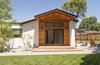 Modern home with Outdoor, Back Yard, Trees, Grass, Vegetables, Shrubs, Flowers, Walkways, Wood Patio, Porch, Deck, Small Patio, Porch, Deck, Wood Fences, Wall, and Landscape Lighting. Private back yard - connected to the master suite Photo 18 of White House
