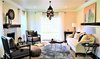 Modern home with Living Room, Sofa, Chair, End Tables, Coffee Tables, Ceiling Lighting, Floor Lighting, Table Lighting, Pendant Lighting, Medium Hardwood Floor, Dark Hardwood Floor, Standard Layout Fireplace, and Wood Burning Fireplace. Overview of Living Room Photo of A 1920's English Cottage
