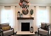 Modern home with Living Room, Chair, Ceiling Lighting, Medium Hardwood Floor, Dark Hardwood Floor, Standard Layout Fireplace, Pendant Lighting, Accent Lighting, and Wood Burning Fireplace. View of Fireplace from Sofa Photo 3 of A 1920's English Cottage