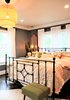 Modern home with Bedroom, Bed, Chair, Bench, Night Stands, Ceiling Lighting, Recessed Lighting, Accent Lighting, Pendant Lighting, Dark Hardwood Floor, and Medium Hardwood Floor. Master Bedroom Bed Photo 17 of A 1920's English Cottage
