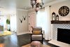 Modern home with Living Room, Chair, Ottomans, Accent Lighting, Pendant Lighting, Ceiling Lighting, Medium Hardwood Floor, Dark Hardwood Floor, Standard Layout Fireplace, and Wood Burning Fireplace. Peek at the Pink front door and Dining Room Photo 5 of A 1920's English Cottage