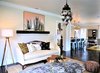 Modern home with Living Room, Coffee Tables, Sofa, Ottomans, End Tables, Ceiling Lighting, Table Lighting, Floor Lighting, Pendant Lighting, Accent Lighting, Medium Hardwood Floor, and Dark Hardwood Floor. View of Living room and peek in to Kitchen Photo 7 of A 1920's English Cottage