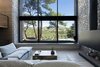 Modern home with Living Room. The facade opens up to the view of the pines trees concealing the boundary between the interior of the house and its surrounding environment Photo 13 of The Wedge House