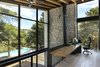 Modern home with Office, Study Room Type, Light Hardwood Floor, and Chair. The facades open up to the view of the pines trees Photo 9 of The Wedge House