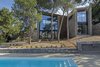 Modern home with Exterior, House Building Type, Shingles Roof Material, Wood Siding Material, Stone Siding Material, and Stucco Siding Material. The house utterly blends with its natural environment Photo of The Wedge House