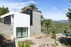 Modern home with Exterior, House Building Type, Stone Siding Material, Wood Siding Material, Shingles Roof Material, and Stucco Siding Material. The house was situated at the mild inclined surface that appeared in the middle of the site Photo 4 of The Wedge House