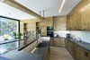 Modern home with Kitchen, Light Hardwood Floor, and Wood Cabinet. The finishes that appear in their natural state give warmth to the house Photo 15 of The Wedge House