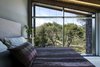 Modern home with Bedroom. The facade opens up to the view of the pines trees concealing the boundary between the interior of the house and its surrounding environment Photo 16 of The Wedge House