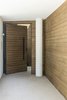 Modern home with Exterior, Stucco Siding Material, and Wood Siding Material. The entrance emerges in a tight exterior passage Photo 7 of The Wedge House