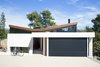 Modern home with Exterior, House Building Type, Shingles Roof Material, and Stucco Siding Material. Two distinct blocks, facing north and west, sit on different levels, and come together in the middle with a wedge-shaped volume that forms the entrance and the vertical circulation leading to the main spaces of the house. A butterfly roof, which reverses the conventional icon of the pitched roof house, lets natural light to enter through those high windows on the back side of the building Photo 6 of The Wedge House