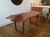 Modern home with Dining Room. Live edge dining table with modern trapezoid shape raw flat metal legs Photo of Park ave apartment NYC