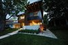 Modern home with Exterior, House Building Type, Mid-Century Building Type, Green Roof Material, Brick Siding Material, Concrete Siding Material, Metal Siding Material, Wood Siding Material, Stucco Siding Material, and Flat RoofLine. Front Exterior Photo 6 of Project 2575