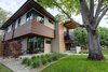 Modern home with Exterior, House Building Type, Mid-Century Building Type, Green Roof Material, Wood Siding Material, Brick Siding Material, Concrete Siding Material, Metal Siding Material, Stucco Siding Material, and Flat RoofLine. Front exterior highlights: mixed use of brick, steel, stucco, concrete and soffit material Photo 4 of Project 2575