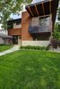 Modern home with Exterior, House Building Type, Mid-Century Building Type, Green Roof Material, Wood Siding Material, Concrete Siding Material, Metal Siding Material, Stucco Siding Material, Flat RoofLine, and Brick Siding Material. Front exterior Photo 3 of Project 2575