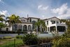 Modern home with House Building Type, Outdoor, Trees, Shrubs, Back Yard, Grass, Gardens, Walkways, Large Pools, Tubs, Shower, and Large Patio, Porch, Deck. Exterior Back: Perfectly poised along the shores of Lake Bessie, this exquisite estate offers more than 11,000 square feet of living space. Photo of 5139 Fairway Oaks Drive