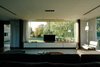 Modern home with Living Room, Sofa, Coffee Tables, Lamps, Media Cabinet, Ceiling Lighting, and Medium Hardwood Floor. Living room Photo 7 of House at Los Cisnes