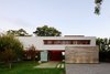 Modern home with Concrete Patio, Porch, Deck, Trees, Large Patio, Porch, Deck, Front Yard, Wood Patio, Porch, Deck, Landscape Lighting, Pavers Patio, Porch, Deck, Exterior, House, Stucco Siding Material, and Concrete Siding Material. Front view of the House at Los Cisnes right before dawn Photo 11 of House at Los Cisnes