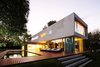 Modern home with Outdoor, Trees, Grass, Swimming Pools, Tubs, Shower, Back Yard, Large Pools, Tubs, Shower, Wood Patio, Porch, Deck, Concrete Pools, Tubs, Shower, Large Patio, Porch, Deck, Metal Patio, Porch, Deck, Concrete Patio, Porch, Deck, Decking Patio, Porch, Deck, and Hanging Lighting. Wooden deck of the House at Los Cisnes at dawn. Concrete, Glass, Wood. Photo 14 of House at Los Cisnes