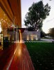 Modern home with Outdoor, Wood Patio, Porch, Deck, Concrete Patio, Porch, Deck, Front Yard, Metal Patio, Porch, Deck, Pavers Patio, Porch, Deck, and Landscape Lighting. Side view of the House at Los Cisnes at dawn. Concrete, Glass, Wood. Photo 12 of House at Los Cisnes
