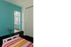 Side-by-side bedrooms for the children are connected through a ‘Jack & Jill’ bathroom. Photo 7 of Suburban Bungalow Grows Up modern home