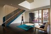 The playroom’s double-height volume binds the first and second floors and provides access to the garden beyond through a covered porch tucked under the Master Suite. Photo 2 of Suburban Bungalow Grows Up modern home