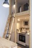 Modern home with Concrete Floor, White Cabinet, Laminate Counter, Recessed Lighting, Ceramic Tile Backsplashe, Dining Room, and Pendant Lighting. Did we mention that Bence loves to cook? Luckily, a fully equipped kitchen found a snug space under the bedroom loft Photo 7 of Micro live:work studio