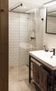 Modern home with Bath Room, Metal Counter, Pedestal Sink, Open Shower, Recessed Lighting, and Ceramic Tile Wall. The bathroom reflects the openness of the apartment itself, with a barely-there glass wall separating the shower Photo 8 of Micro live:work studio