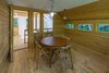 Modern home with Small Patio, Porch, Deck, Trees, Wood Patio, Porch, Deck, Hanging Lighting, and Exterior. The “Poker Terrace” is the back-of-the-house getaway for the family’s adult children and their friends Photo 10 of A Family Affair