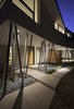 Modern home with Outdoor, Hardscapes, Stone Patio, Porch, Deck, Side Yard, Metal Fences, Wall, Walkways, and Grass. An array of columns partially support the second floor Photo 2 of 6th Street