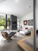 Modern home with Living Room, Coffee Tables, Chair, Sofa, Concrete Floor, Recessed Lighting, and Gas Burning Fireplace. The living room features an Eames lounge chair and ottoman from Design Within Reach and original artwork by Bill Snider Photo 8 of 6th Street