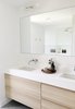 Modern home with Bath Room, Engineered Quartz Counter, Ceramic Tile Floor, Undermount Sink, Open Shower, Wall Lighting, Ceramic Tile Wall, and Subway Tile Wall. The master bathroom features Ikea cabinets with a custom vanity - the perfect mix of high and low. A massive walk-in shower and oversized window make this entire space feel like a spa. Photo 5 of The Simply Simple Home
