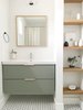 Modern home with Bath Room, Wall Lighting, Porcelain Tile Floor, and Subway Tile Wall. The guest bathroom utilizes a simple Ikea vanity custom painted to the perfect shade of green and features leather hardware from the Australian company Made Measure. Photo 6 of The Simply Simple Home